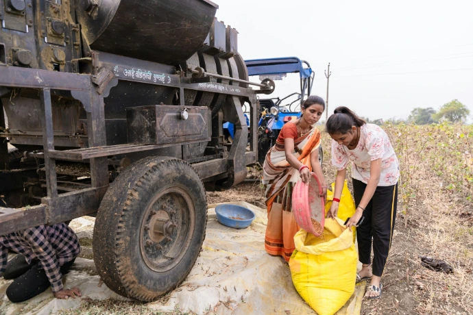 a group of people standing next to a truck